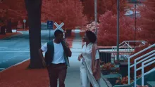 A man and a woman wlaking down the sidewalk